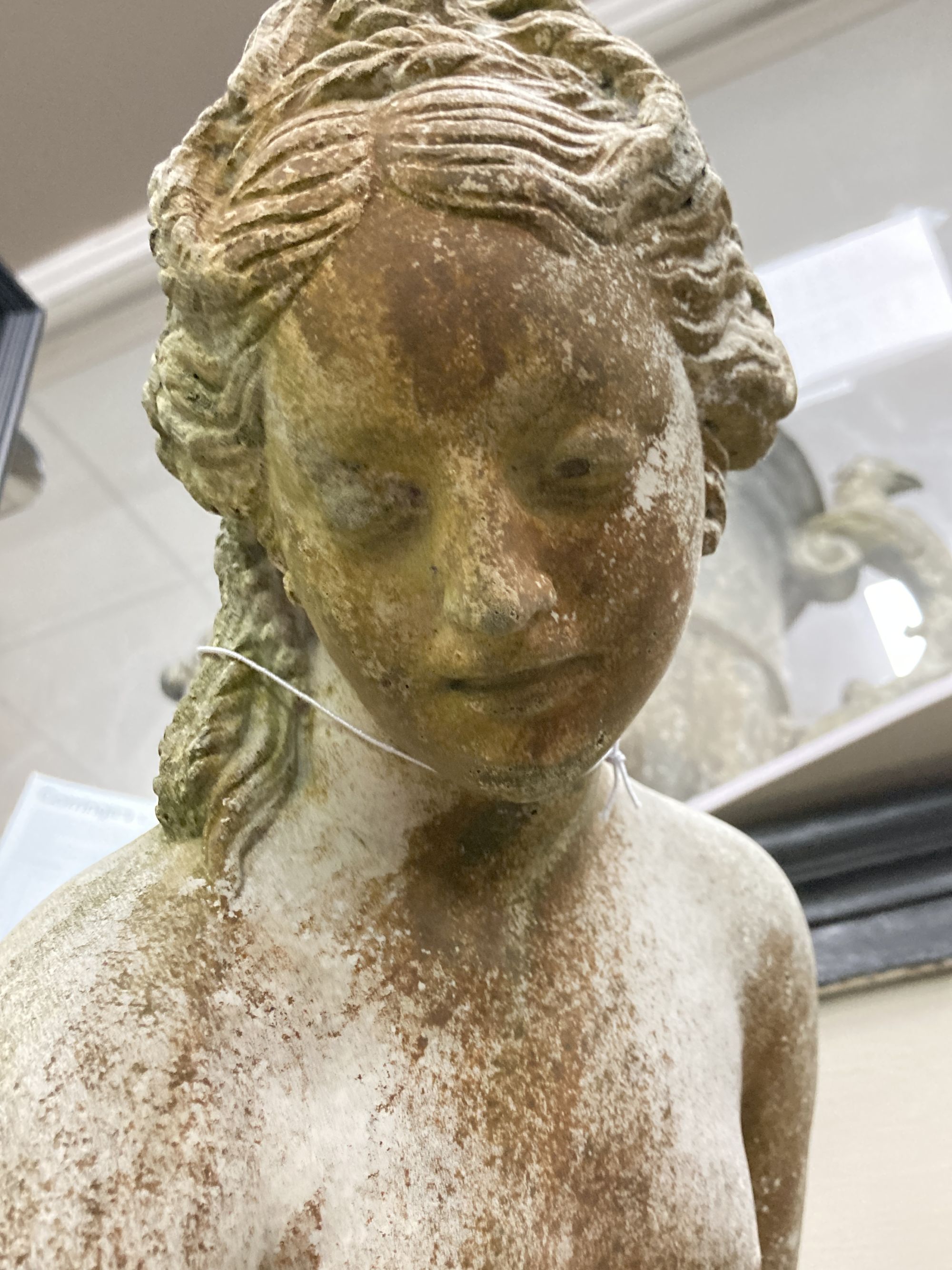 A reconstituted stone garden ornament of a female bather, 86cm high